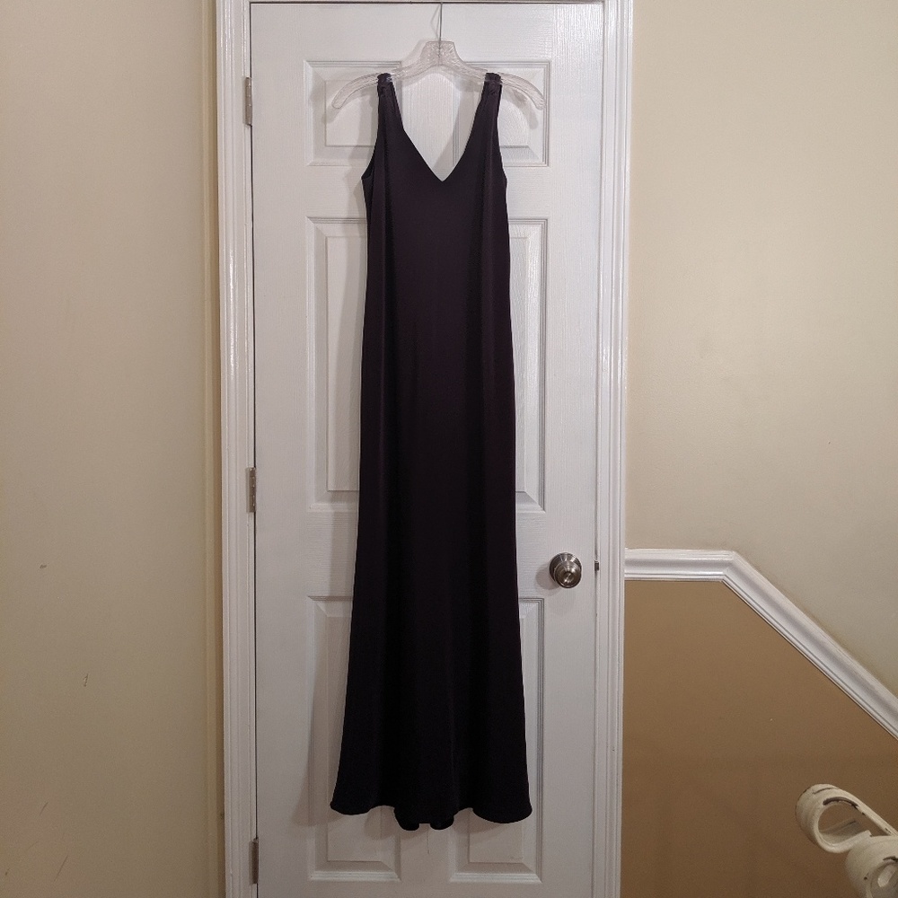 Evening gown with draped back and flowing bottom.